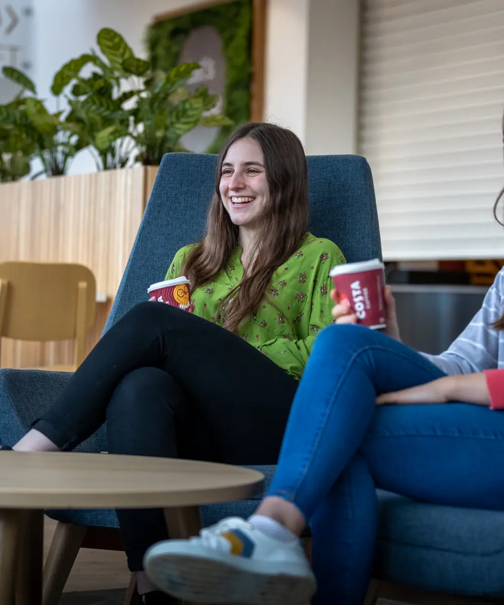 Two international students sat in Graze restaurant enjoying a hot drink