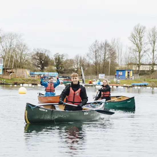 Image of students in boats on the lake rowing