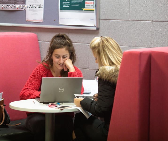 Two females students studying with laptop